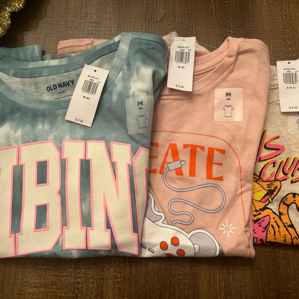 3 NWT Old Navy Girls T-Shirts - Size S (1), Size M (2). Never been worn.